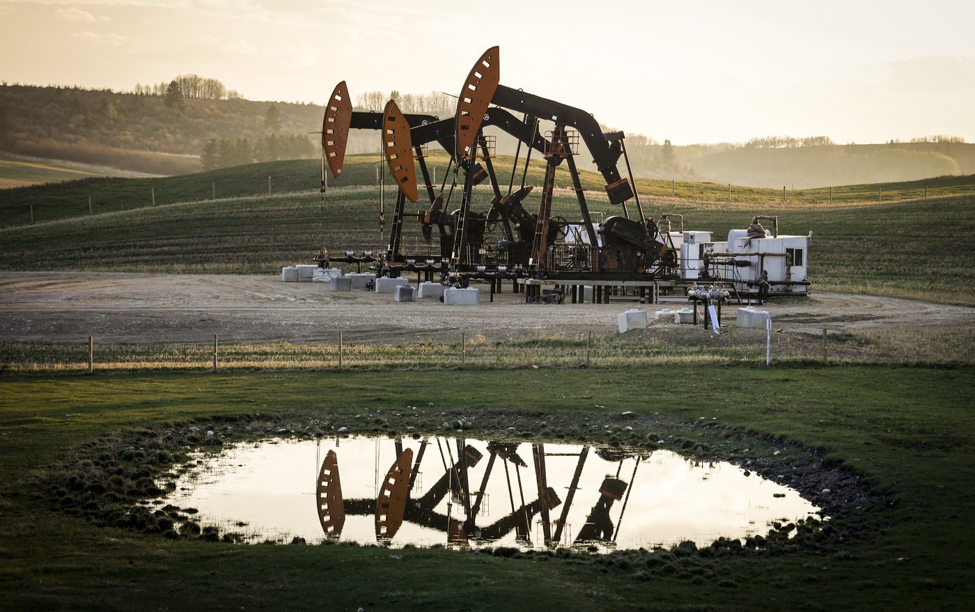 Pumpjacks draw out oil and gas from a well heads as wildfire smoke hangs in the air near Calgary, Alta., on Sunday, May 12, 2024. THE CANADIAN PRESS/Jeff McIntosh