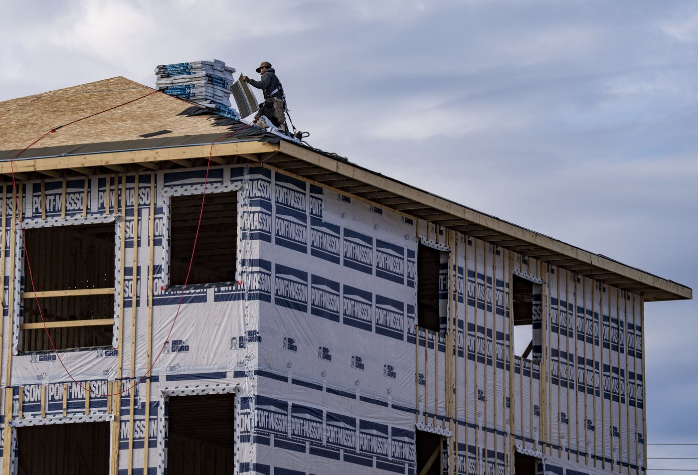 A roofer is seen working on a new housing development in Salaberry-de-Valleyfield, Que., southwest of Montreal on Wednesday, Oct. 22, 2025. THE CANADIAN PRESS/Christinne Muschi