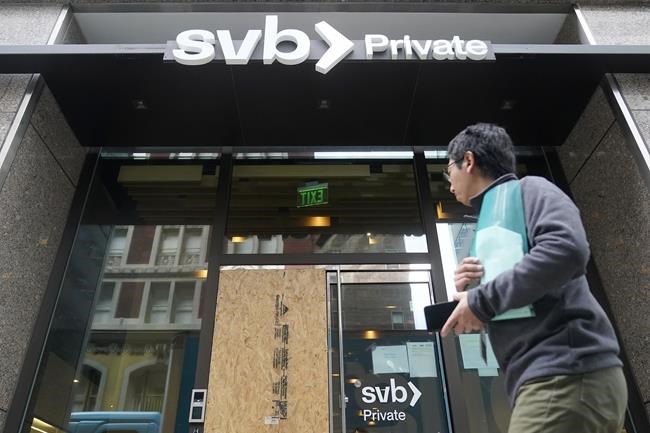A pedestrian passes a Silicon Valley Bank Private branch in San Francisco, Monday, March 13, 2023. THE CANADIAN PRESS/AP-Jeff Chiu