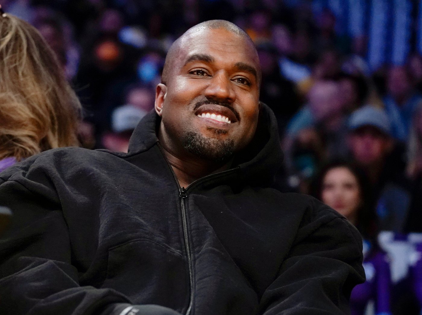 FILE - Kanye West, known as Ye, watches the first half of an NBA basketball game between the Washington Wizards and the Los Angeles Lakers, on March 11, 2022, in Los Angeles. (AP Photo/Ashley Landis, File)