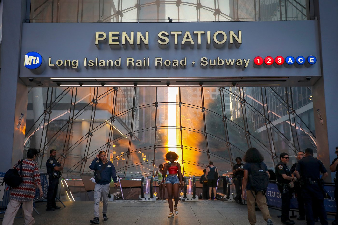 FILE - Commuters pass Penn Station and Madison Square Garden, July 2, 2026, in New York. (Photo by Andy Kropa/Invision/AP, File)