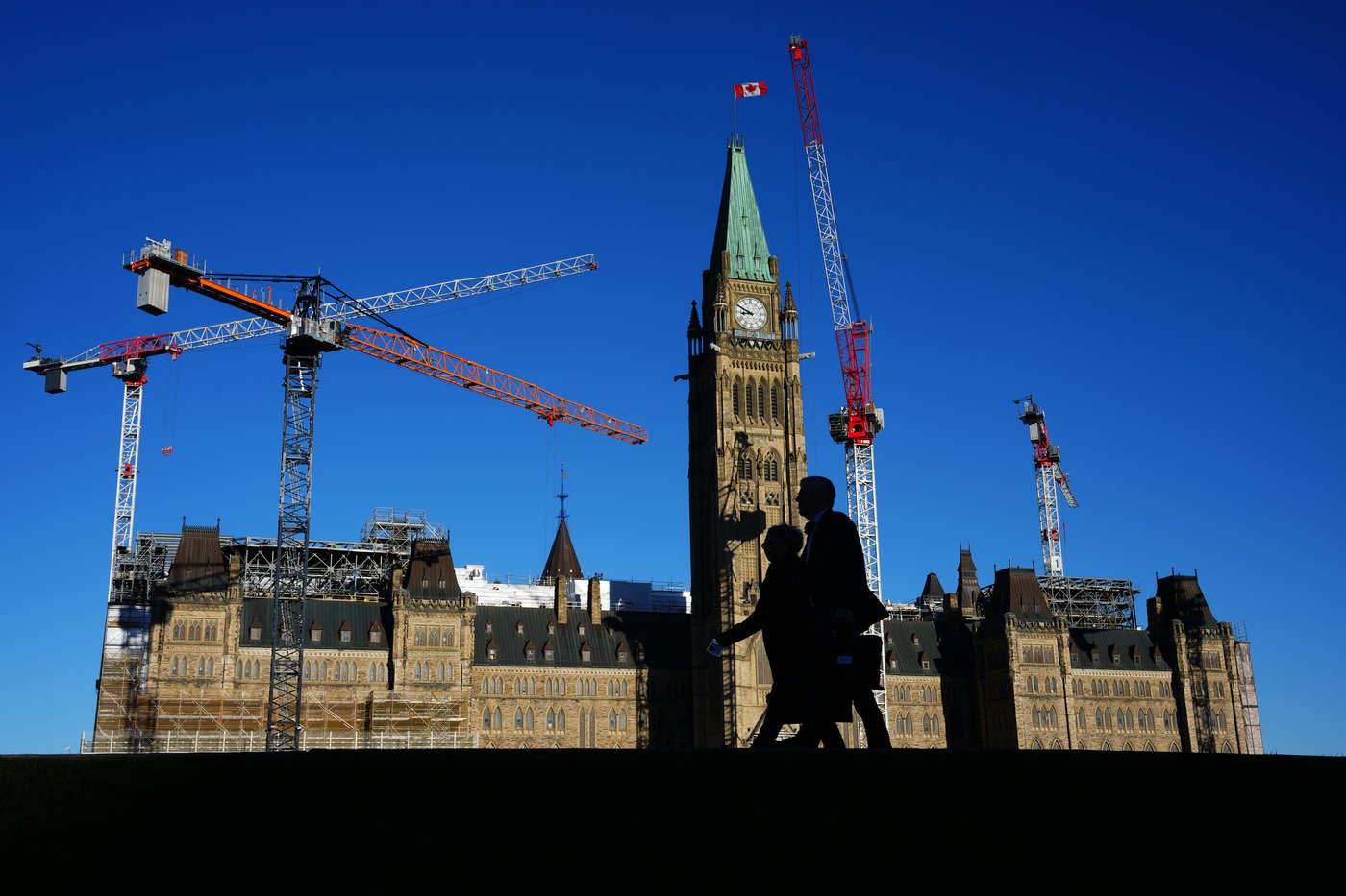 People walk past the Peace Tower on Parliament Hill in Ottawa, Tuesday, Nov. 4, 2025. THE CANADIAN PRESS/Sean Kilpatrick