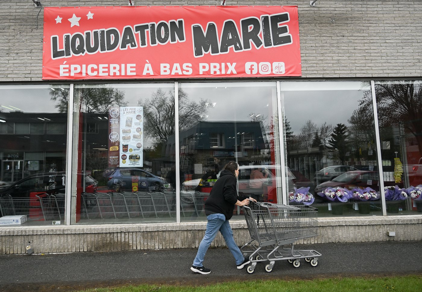 A person enters a Liquidation Marie grocery store in Longueuil, Que., on Thursday, May 14, 2026. THE CANADIAN PRESS/Graham Hughes