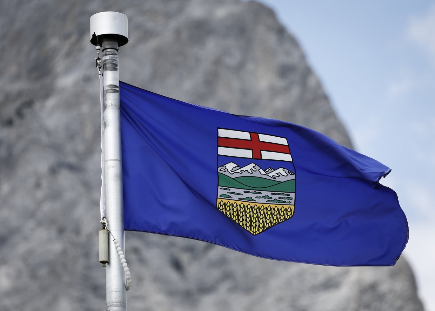 An Alberta flag flaps in the breeze with Mt. Kidd in the background at the site of the G7 Leaders meeting in Kananaskis, Alta., Monday, June 2, 2025.THE CANADIAN PRESS/Jeff McIntosh