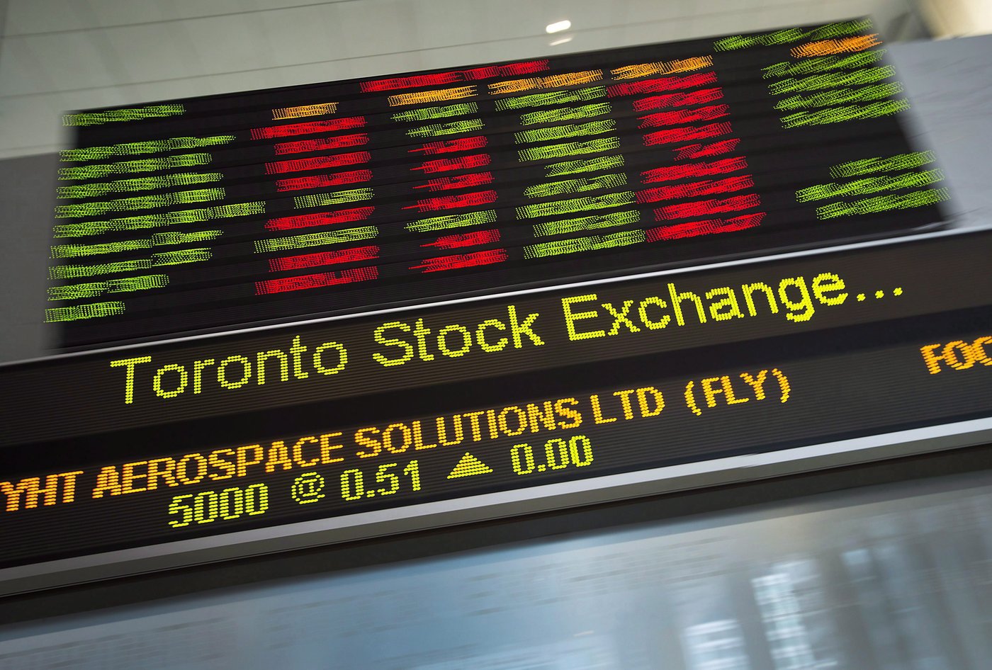 Financial numbers flow on the digital ticker tape at the TMX Group in Toronto's financial district on May 9, 2014. THE CANADIAN PRESS/Darren Calabrese