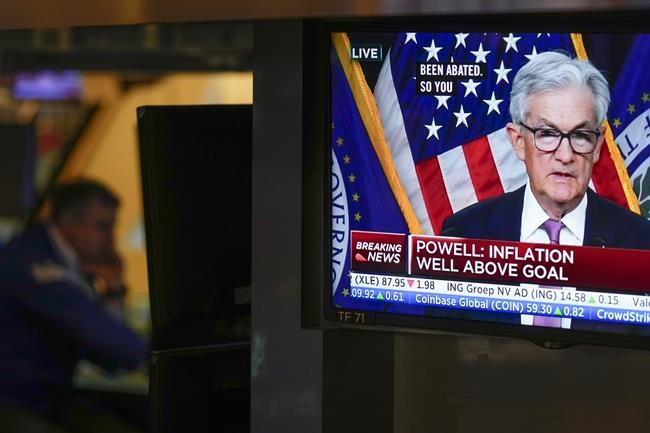 Traders on the floor at the New York Stock Exchange watch Federal Reserve Chair Jerome Powell's news conference after the Federal Reserve interest rate announcement in New York, Wednesday, Feb. 1, 2023. (AP Photo/Seth Wenig)