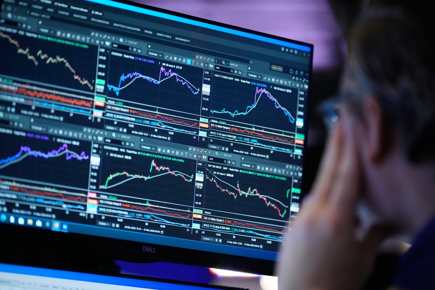 A screen displays financial information on the floor at the New York Stock Exchange in New York, Tuesday, March 31, 2026. (AP Photo/Seth Wenig)