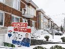 A real estate sign shows a home for sale in Montreal on Monday, March 24, 2025. THE CANADIAN PRESS/Christinne Muschi