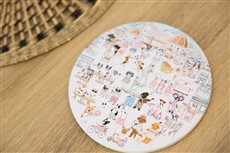 A round white plate with cartoon images on itDescription automatically generated