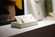 A white box with gold necklaces and earringsDescription automatically generated