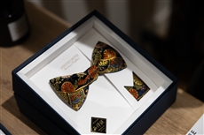 A bow tie in a boxDescription automatically generated