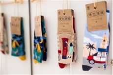 Several pairs of socks on a wallDescription automatically generated