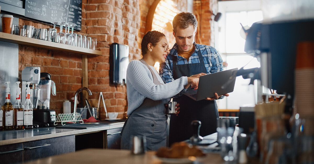 cafe workers looking at laptop