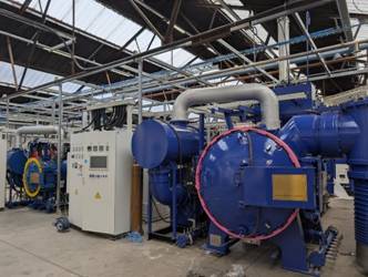 A large blue machine in a factory AI-generated content may be incorrect.