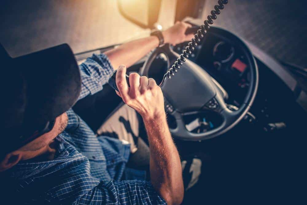 A trucker uses his CB radio. (Photo: Shutterstock)