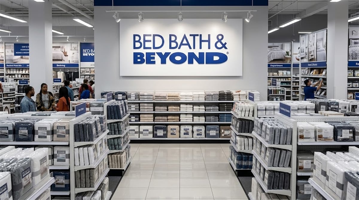 Interior of a Bed Bath and Beyond retail store with shoppers browsing shelves stocked with bedding products.