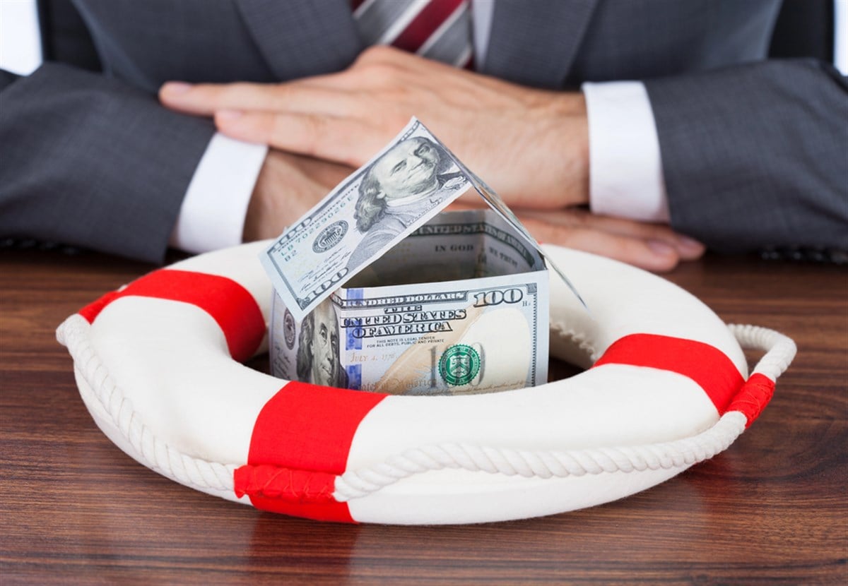 House made of dollar bills inside a life preserver.