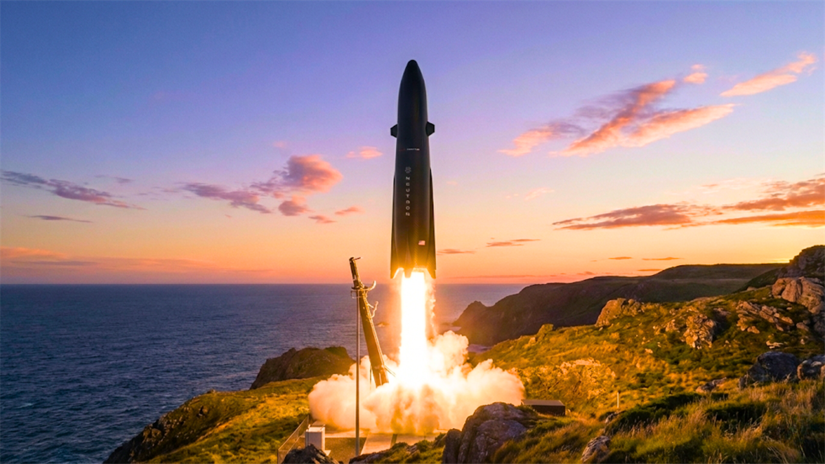 Rocket launch at coastal pad at sunset, highlighting commercial space industry growth and space stocks.
