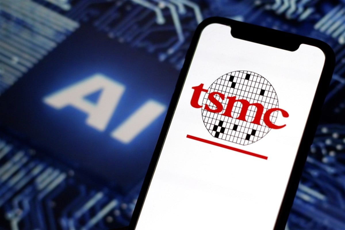 TSMC logo on a smartphone screen, with AI on a semiconductor chip in the background