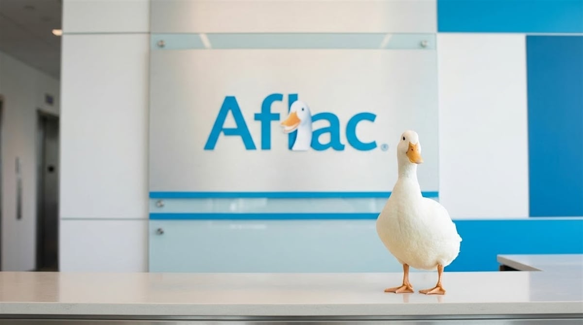 The Aflac duck mascot stands on a reception desk in front of the Aflac corporate logo.