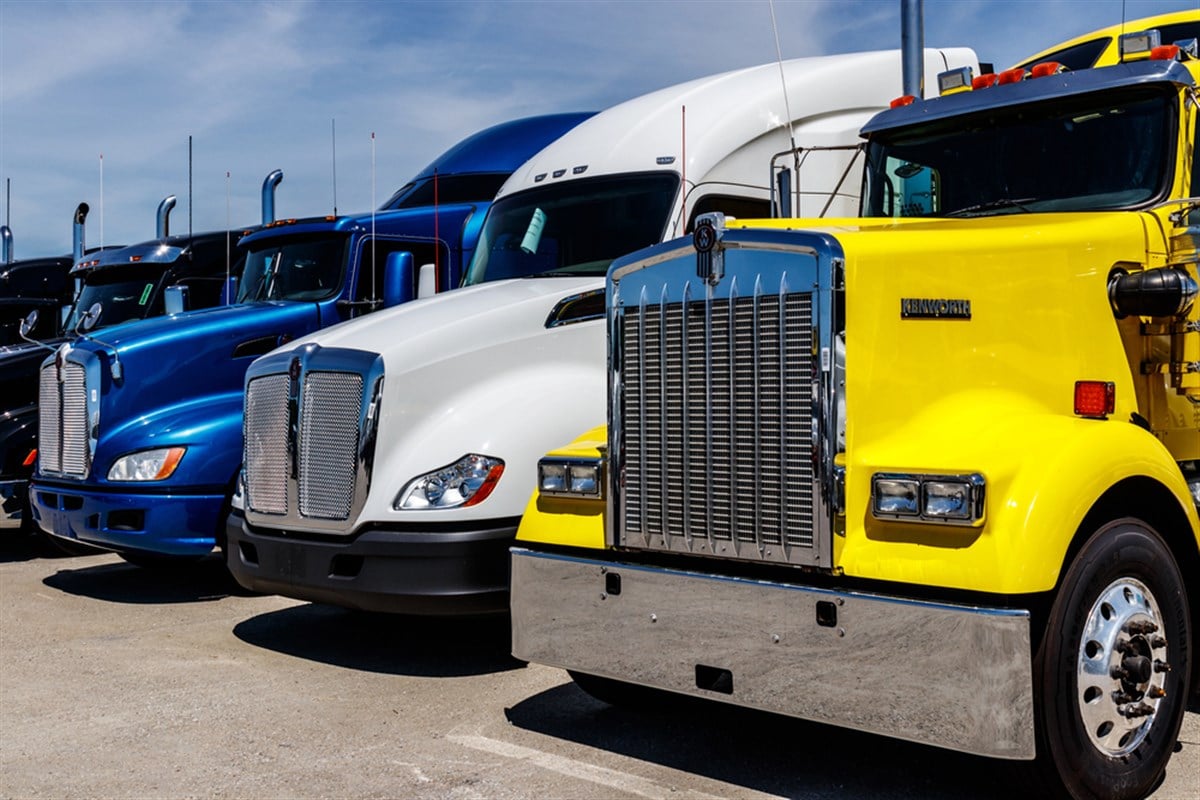 Indianapolis - Circa June 2018: Colorful Semi Tractor Trailer Trucks Lined up for Sale I - Stock Editorial Photography