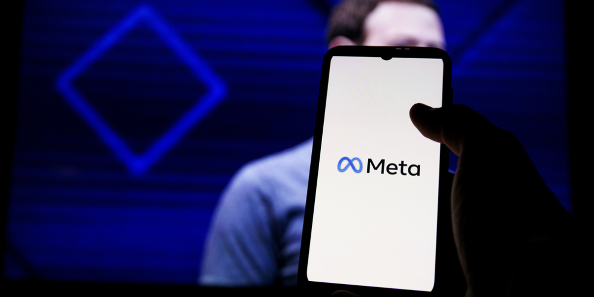 Meta logo on screen and Mark Zuckerberg is a Chief Executive Officer of Metaverse in background - Stock Editorial Photography