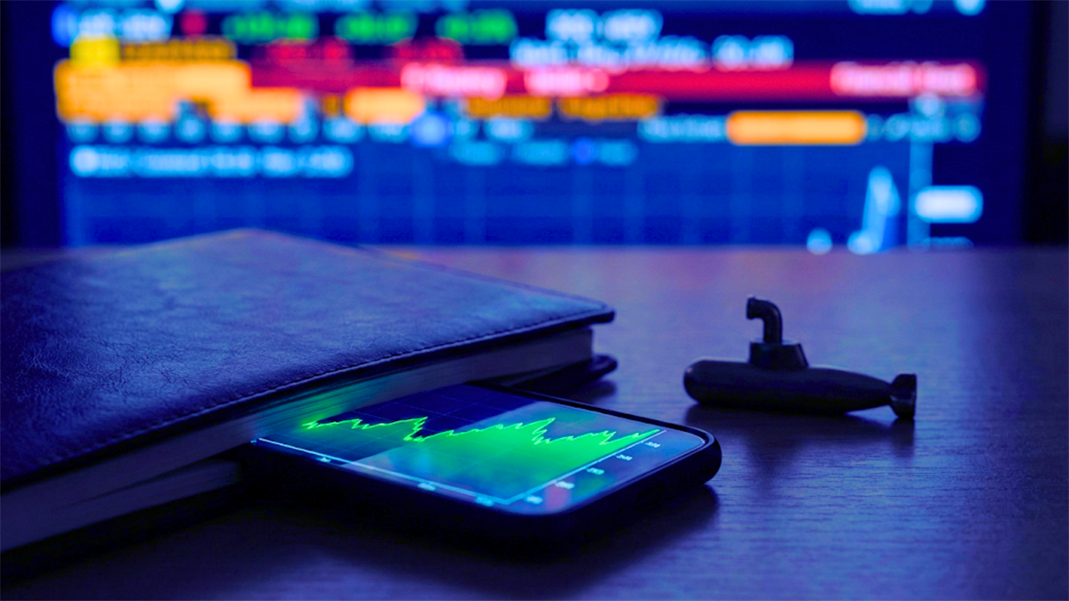 Smartphone displays rising stock chart beside notebook as market screen hints at under-the-radar earnings winners.