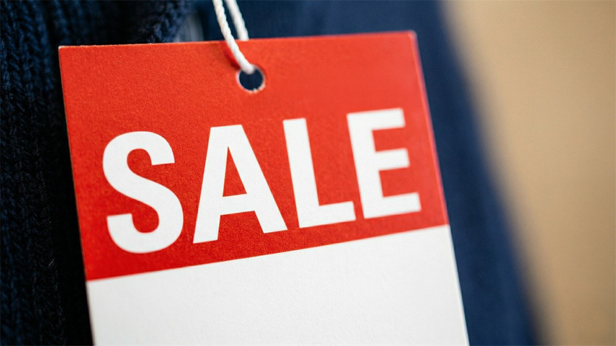 Red sale tag hanging from clothing, symbolizing stocks at discounted valuations.
