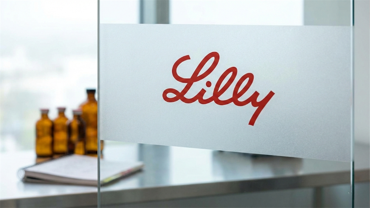 Lilly logo appears on frosted glass in a lab setting, underscoring the company’s leadership in pharmaceuticals.