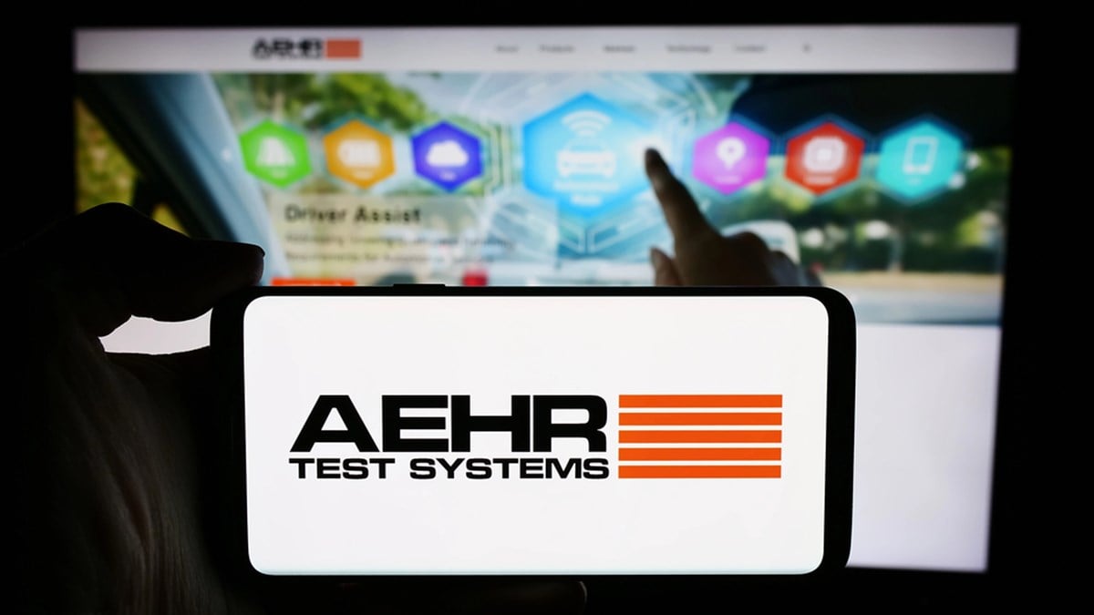 Stuttgart, Germany - 04-28-2024: Person holding cellphone with logo of US semiconductor testing company Aehr Test Systems in front of business webpage. Focus on phone display.
