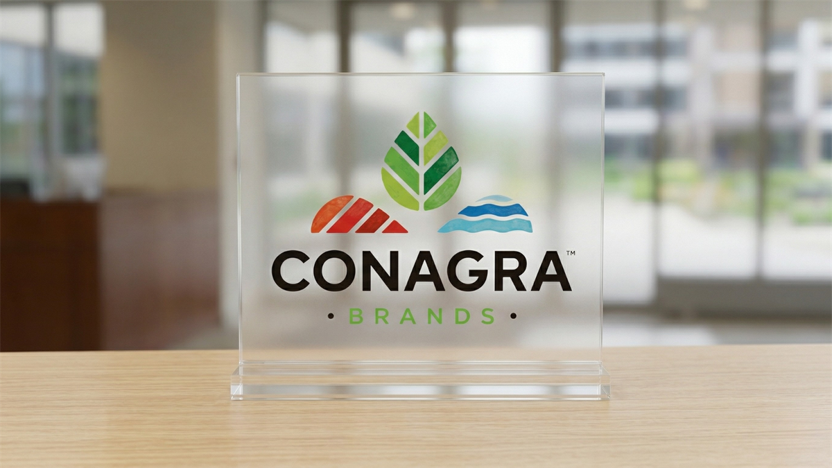 Conagra Brands logo displayed on a clear glass plaque, symbolizing packaged food industry and stock rebound potential.