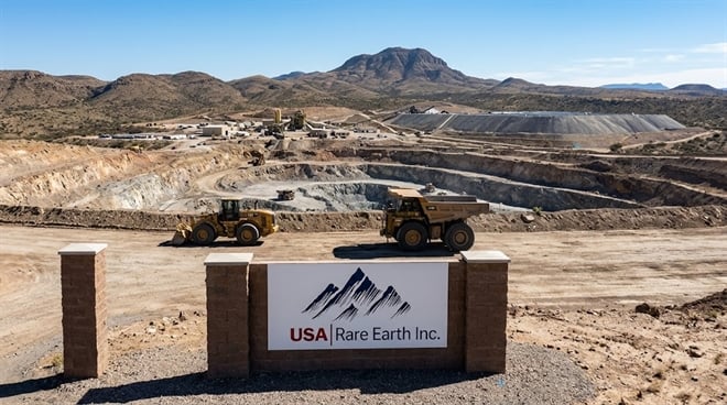 USA Rare Earth Inc. signage at the entrance of an open-pit mining operation in an arid landscape.