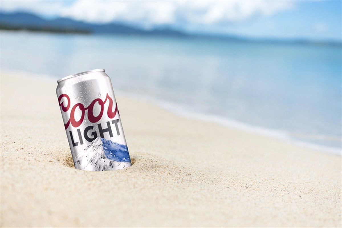 Photo of Coors Light can in the sand at the beach
