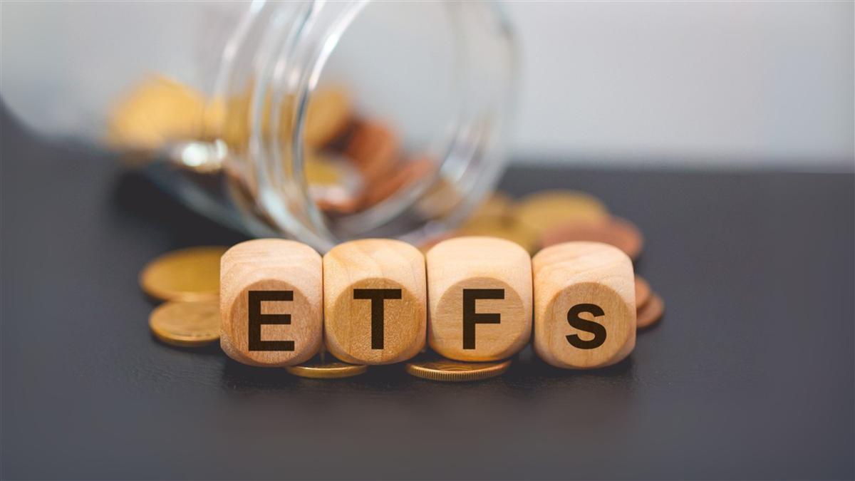 Acronym etfs written on wooden cubes and piles of coins. Studio photo. — Photo