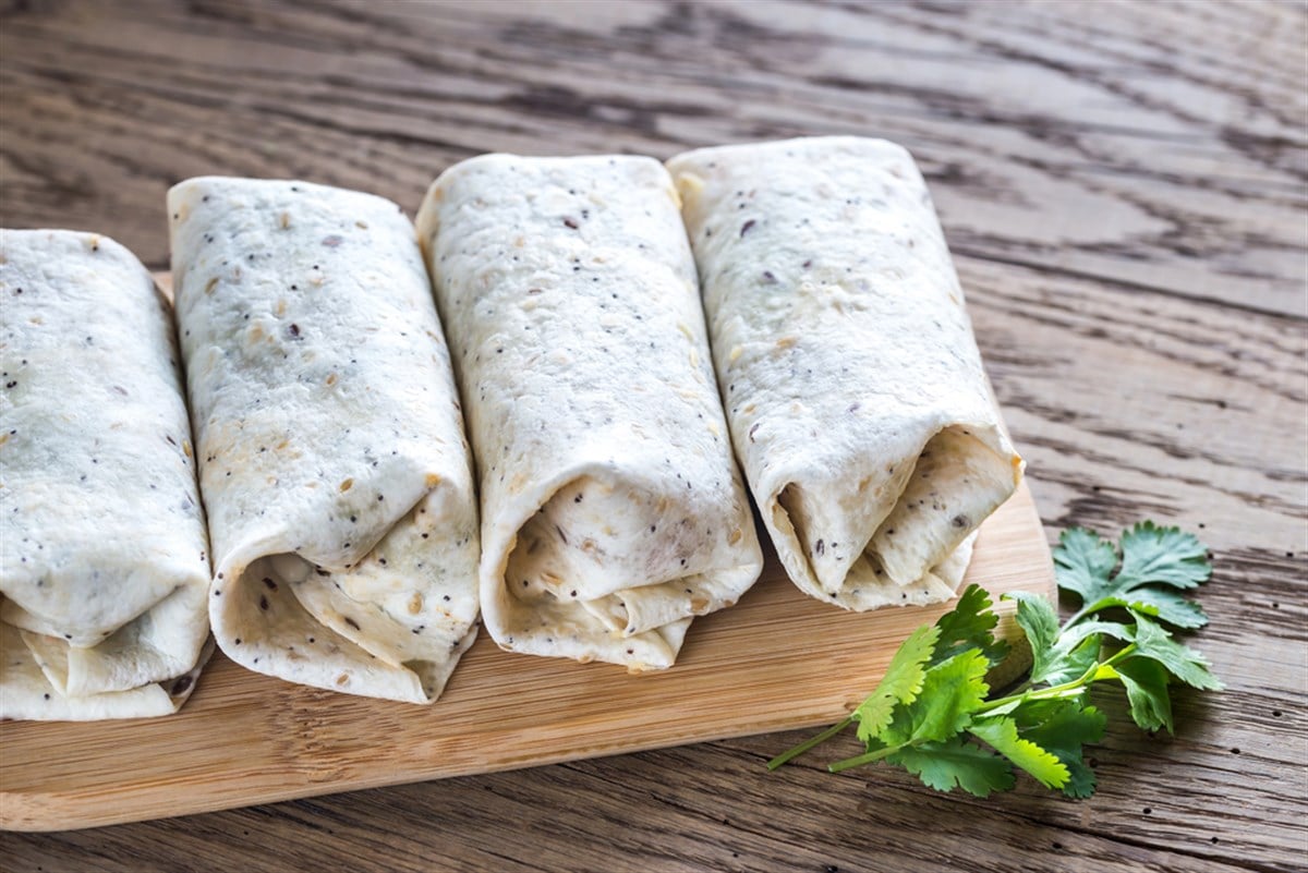 Burritos on a wooden surface