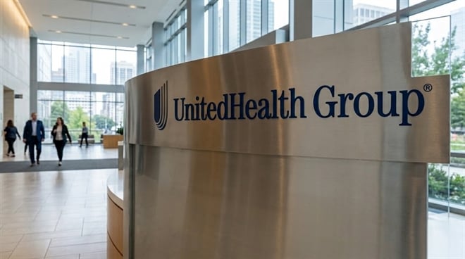 UnitedHealth Group logo displayed on a metal reception desk in a corporate office lobby.