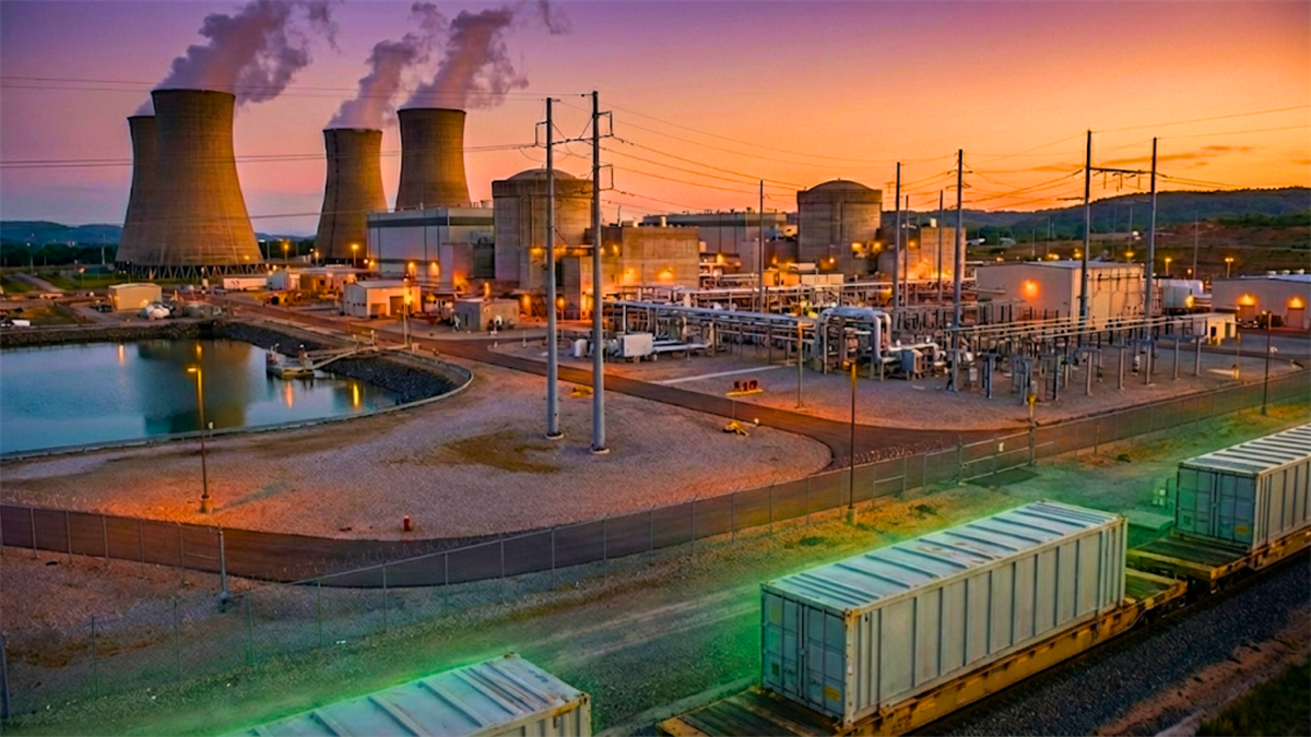 Nuclear power plant at dusk with cooling towers and rail cars, highlighting uranium demand and energy market focus.