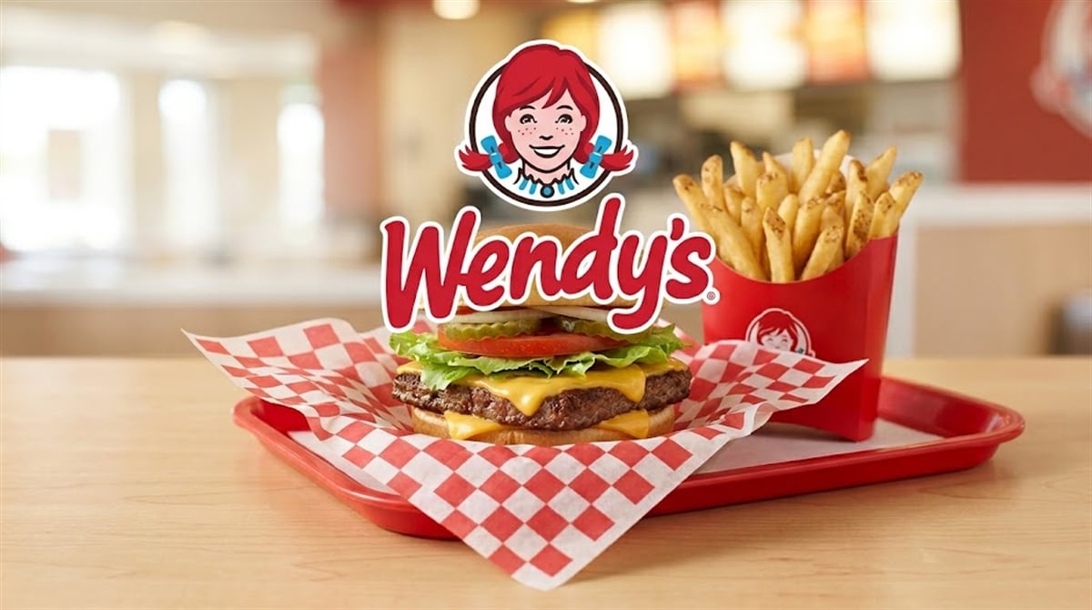 Wendy's logo displayed above a cheeseburger and french fries on a restaurant tray.