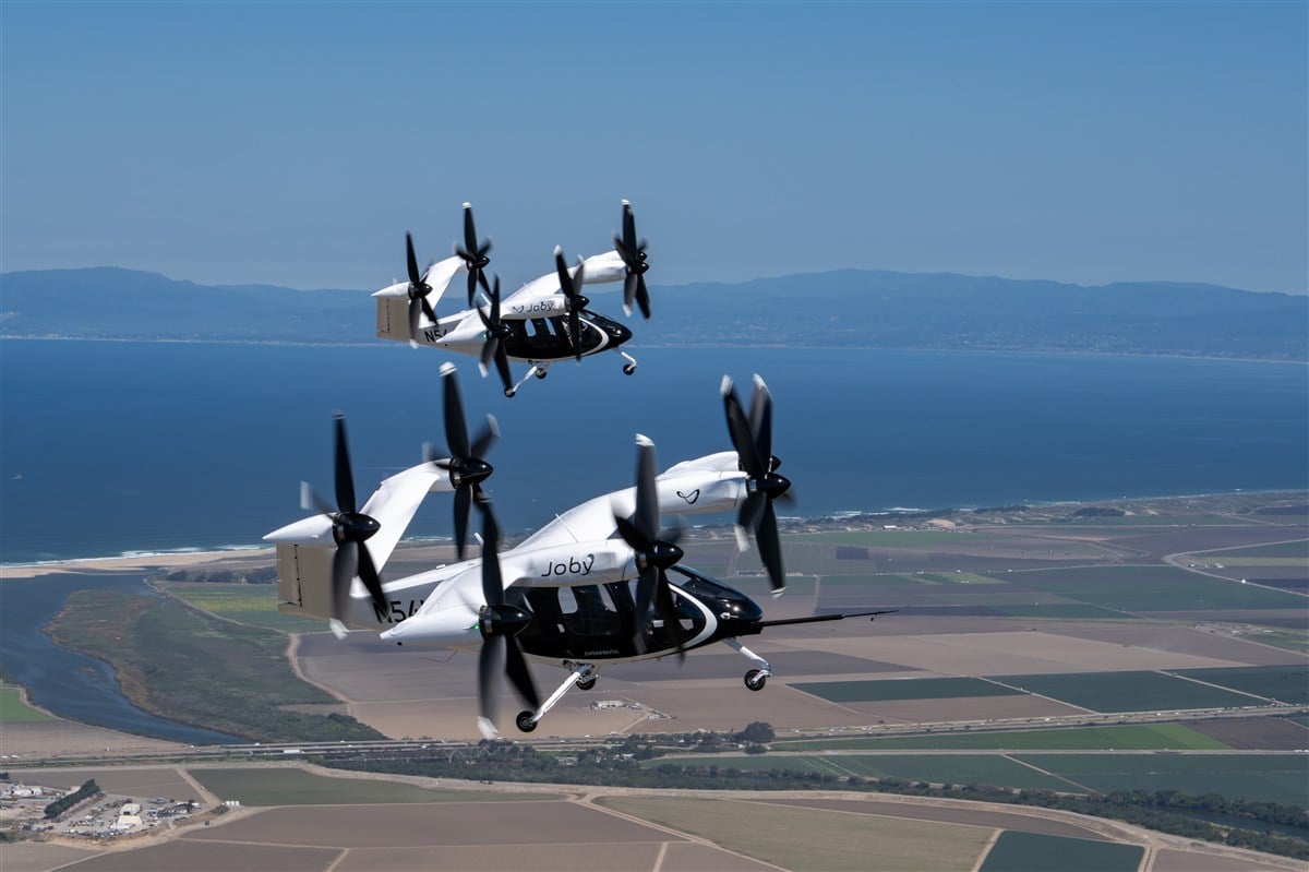 Photo of two joby aircraft flying. Courtesy of Joby Aviation. (c) Joby Aero, Inc.