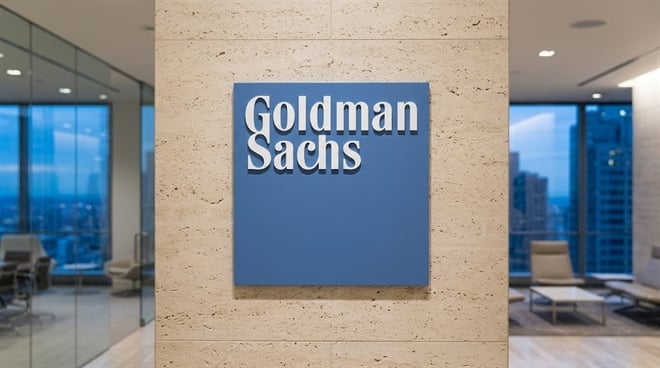 The Goldman Sachs logo mounted on a textured stone pillar in a modern corporate office.