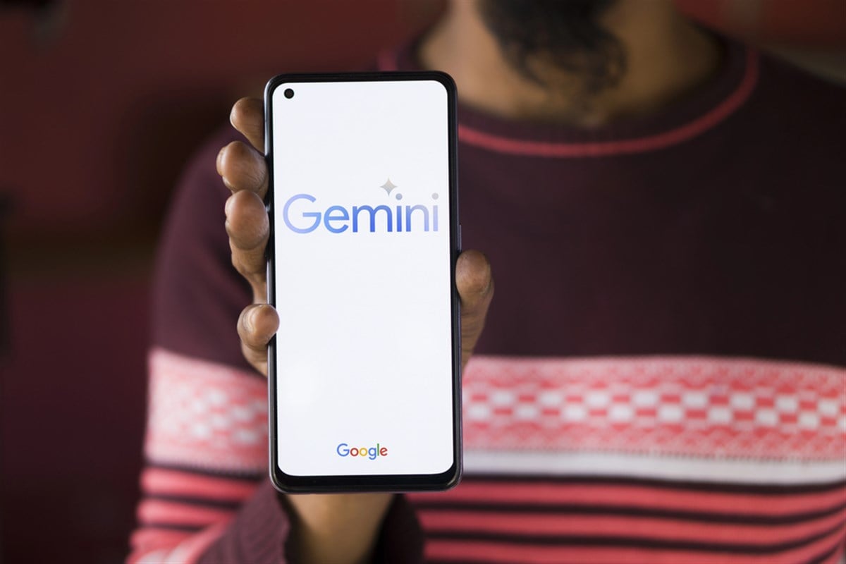 Hand holds google phone with Google Gemini chatbot.