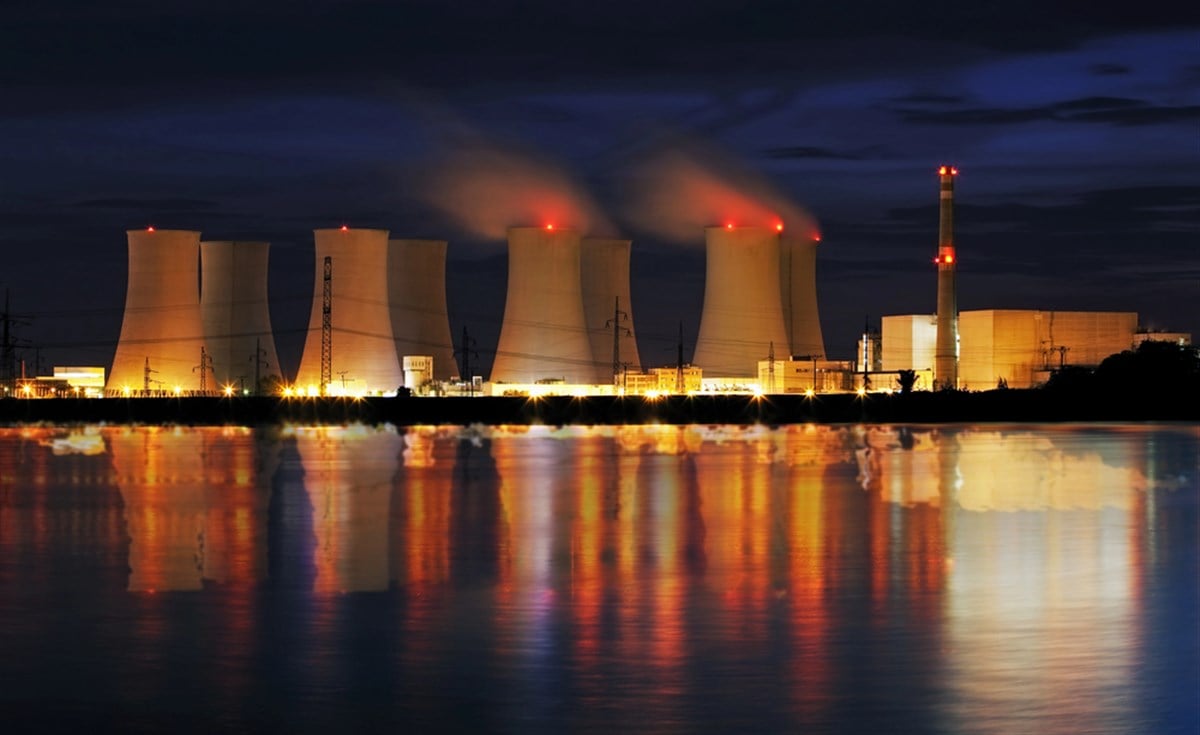 Photo of nuclear power plant by night with reflection