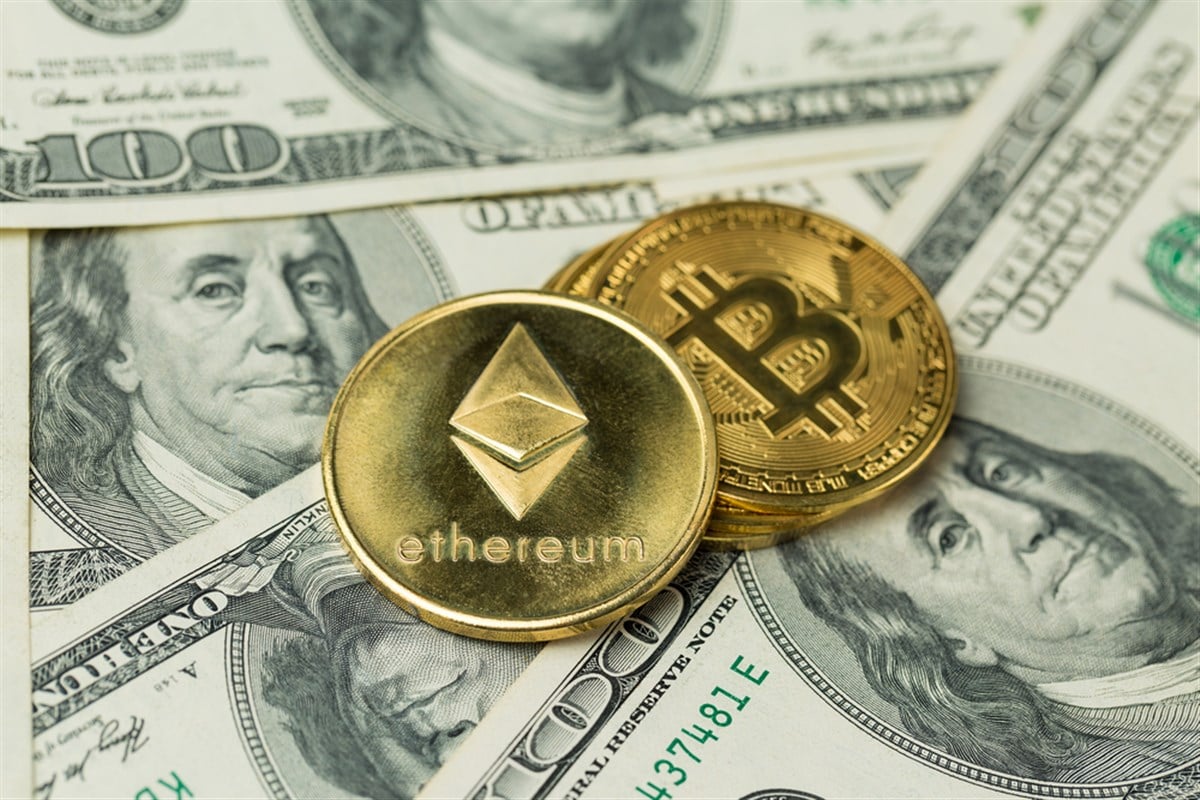 Cryptocurrency golden coins - Bitcoin, Ethereum, Litecoin against the background of a 100 dollar bill. Virtual money concept. - Stock Editorial Photography