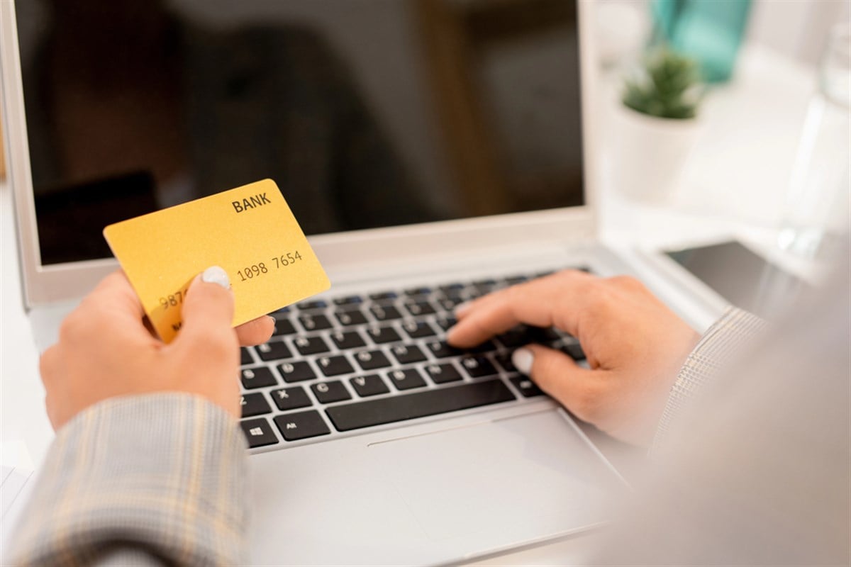 Businesswoman enters her payment information into an online portal.
