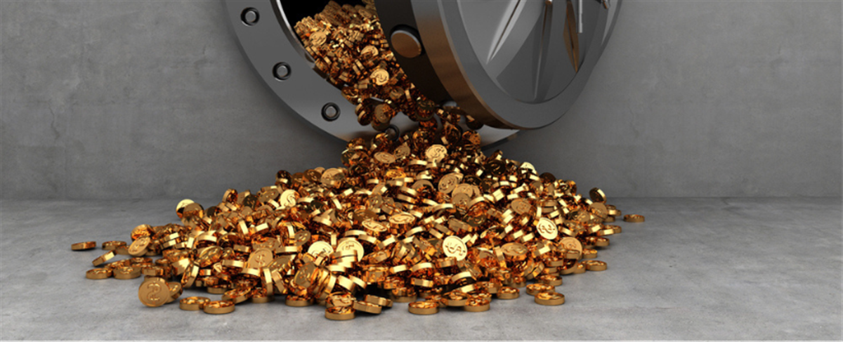 Photo of gold coins spilling from a vault