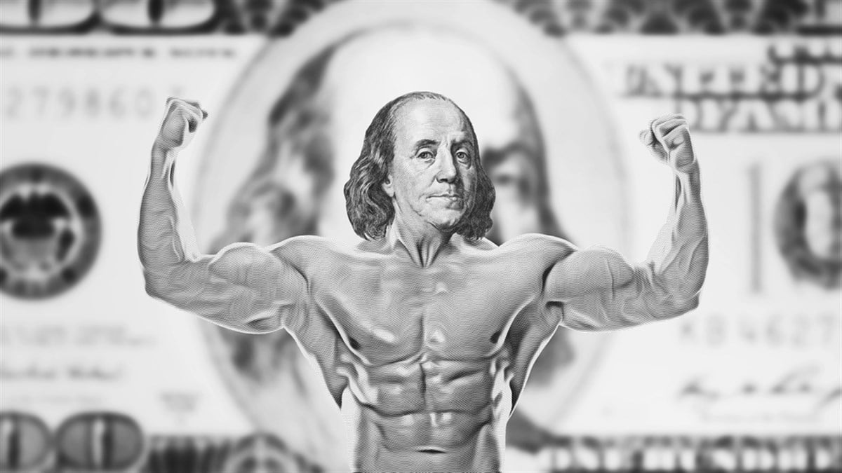 Muscular benjamin franklin showing double biceps. strong dollar symbol of stability and security.