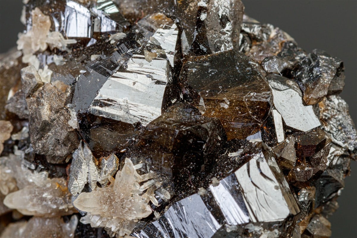 Macro mineral cassiterite stone on gray background