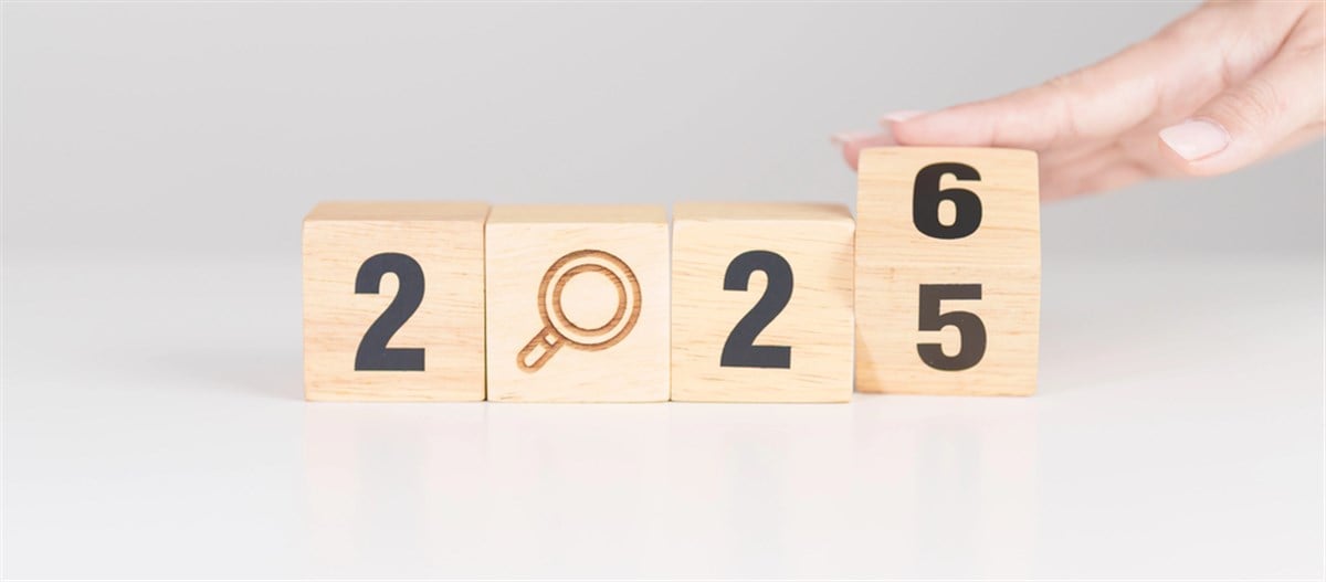 2025 year change to 2026 blocks with magnifying glass icon.