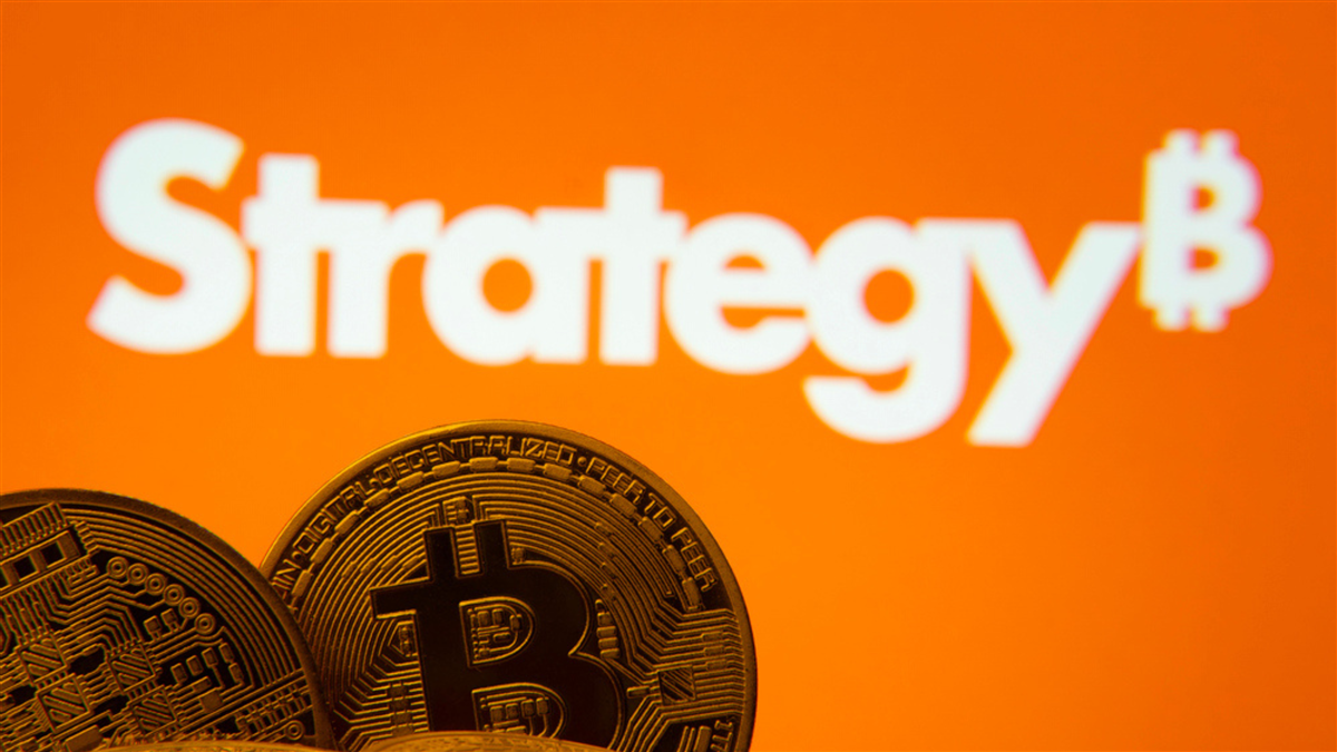 Dhaka, Bangladesh- 27 March 2025: Close-up of Bitcoin coins with the MicroStrategy logo visible on a screen in the background.