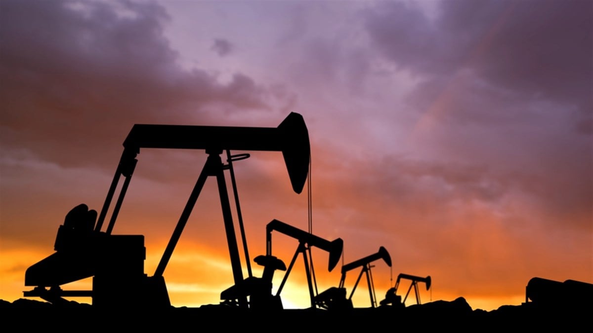 Modern methods of power industry technology creative advertisement concept. Shot of oilfield heads against sunset sky. Many drilling rig units towers extracting crude oil from the soil.